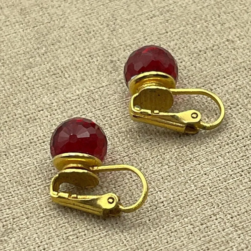 Vintage red glass multi faceted gold tone clip on earrings